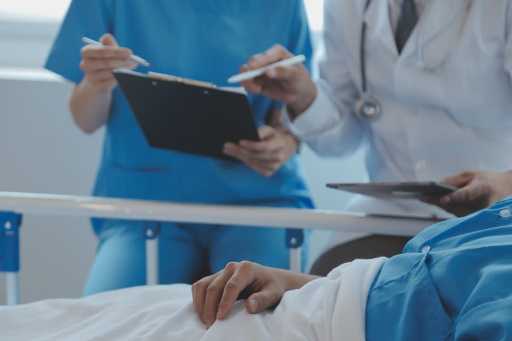 Doctors reviewing a patient’s medical records before filing a medical malpractice claim
