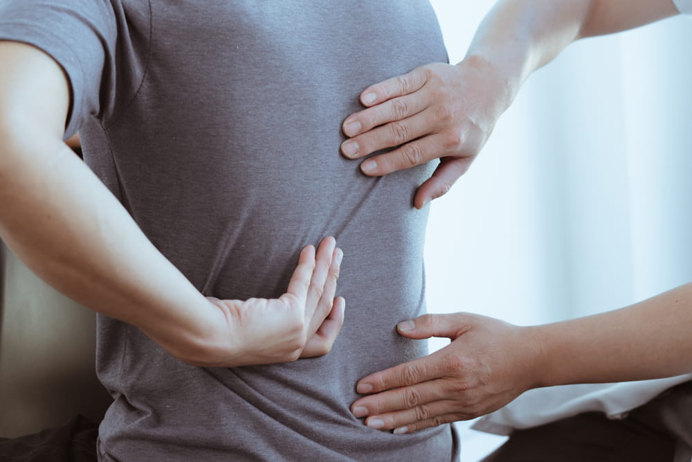 Person receiving treatment for back pain after a car accident